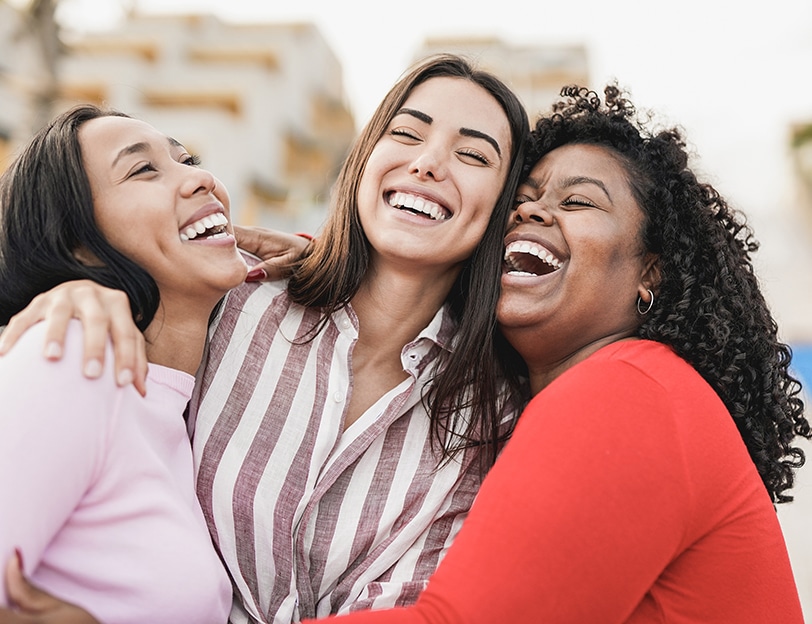 three girls laughing next to each other after a dentist appointment at vivere meliora dentistry