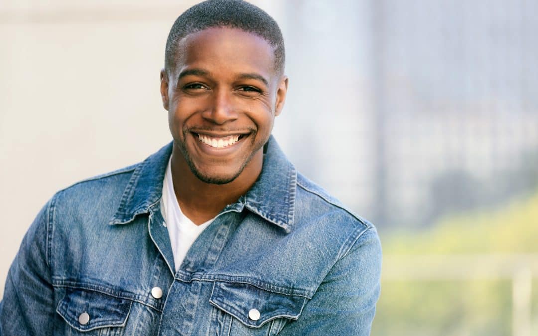 Man showing off his smile transformation with cosmetic dentistry from Vivere Meliora Dentistry in St Johns FL